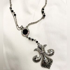 Fleur de lis long length jeweled necklace.